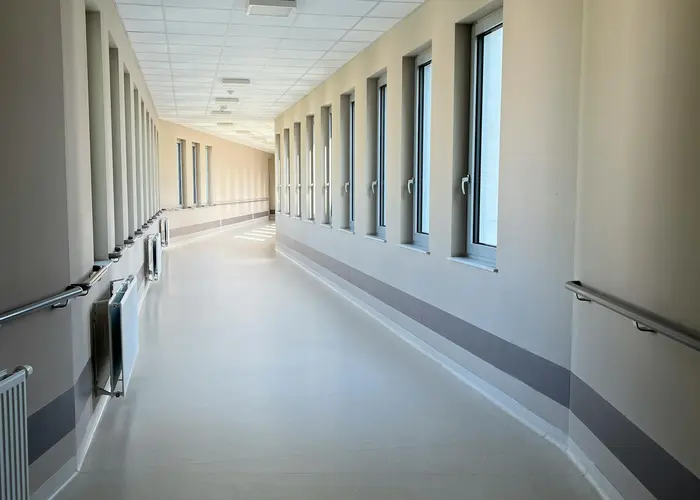 A bright, modern hospital corridor with large windows