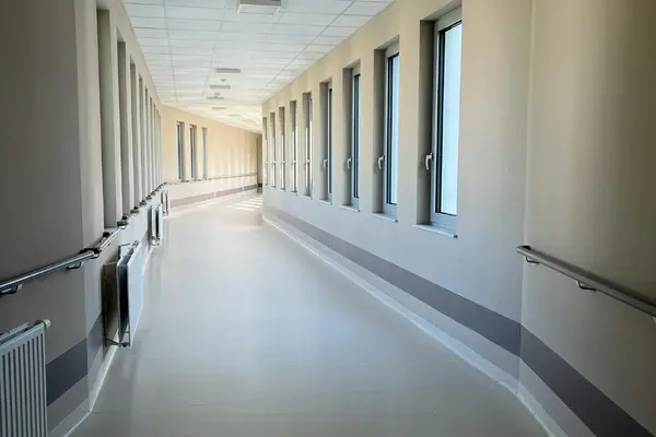 A bright, modern hospital corridor with large windows